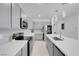A kitchen featuring grey cabinets, stainless steel appliances, and a large island with quartz countertops at 5357 Eleganza Ave, Pahrump, NV 89061