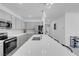 Bright modern kitchen with stainless steel appliances, gray cabinets, and quartz countertops at 5357 Eleganza Ave, Pahrump, NV 89061