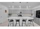 Bright kitchen with a quartz island, pendant lighting, grey cabinets and stainless steel appliances at 5357 Eleganza Ave, Pahrump, NV 89061