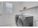Laundry room with black washing machine and dryer at 5357 Eleganza Ave, Pahrump, NV 89061