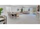 Open-concept living room with a dining area, large windows, and modern décor at 5357 Eleganza Ave, Pahrump, NV 89061