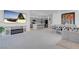 Spacious living room with a fireplace, modern decor, and an open layout, seamlessly connecting the kitchen and dining area at 5357 Eleganza Ave, Pahrump, NV 89061