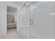 Bright white walk-in shower with glass enclosure and bench seating at 5357 Eleganza Ave, Pahrump, NV 89061