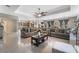 Open floorplan showcases two large sofas, decorative floral arrangement, and a view into the kitchen at 5872 Revital Ct, Las Vegas, NV 89131