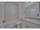 Clean bathroom featuring granite vanity, white cabinets, and tiled shower-tub at 610 San Lorenzo St, Pahrump, NV 89048