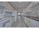 A long kitchen with white appliances and bright modern cabinets at 610 San Lorenzo St, Pahrump, NV 89048
