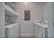 Laundry room with washer, dryer and storage shelf at 610 San Lorenzo St, Pahrump, NV 89048