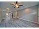 Spacious open-concept living area with wood flooring, ceiling fan, and recessed lighting at 610 San Lorenzo St, Pahrump, NV 89048