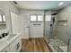 Bathroom featuring a glass shower, modern fixtures, and hardwood flooring at 6191 Bullion Blvd, Las Vegas, NV 89103