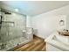 Bathroom featuring a glass shower, modern fixtures, and hardwood flooring at 6191 Bullion Blvd, Las Vegas, NV 89103