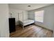Bright bedroom features wood floors, a large window, and a modern black dresser at 6191 Bullion Blvd, Las Vegas, NV 89103