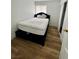 Cozy bedroom with wood floors, bright window, and a comfortable bed at 6191 Bullion Blvd, Las Vegas, NV 89103