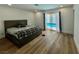 Bedroom featuring hardwood flooring and sliding glass doors that open to the pool at 6191 Bullion Blvd, Las Vegas, NV 89103