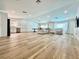 Expansive living room featuring wood floors, recessed lighting, a large sofa, and an open concept at 6191 Bullion Blvd, Las Vegas, NV 89103