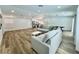 Large living room with a kitchen, dining, and an open layout featuring recessed lighting and wood floors at 6191 Bullion Blvd, Las Vegas, NV 89103
