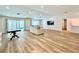 Open-concept living room with sliding glass doors leading to a pool and wood style flooring at 6191 Bullion Blvd, Las Vegas, NV 89103