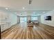 Bright and airy living room with wood floors and sliding glass doors to the pool area at 6191 Bullion Blvd, Las Vegas, NV 89103