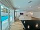Living room with sliding glass doors to the pool area, wood flooring, and recessed lighting at 6191 Bullion Blvd, Las Vegas, NV 89103