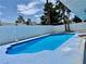 Inviting backyard pool, framed by white fencing and lush trees, ready for summer enjoyment at 6191 Bullion Blvd, Las Vegas, NV 89103