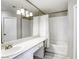 Neutral bathroom with a large mirror, a white vanity and a tub with shower at 6250 W Flamingo Rd # 43, Las Vegas, NV 89103