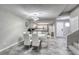 Bright dining area featuring a modern light fixture, white table, and chairs next to the kitchen at 6250 W Flamingo Rd # 43, Las Vegas, NV 89103