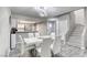 Open floor plan showcasing kitchen, dining area with marble table, and stairs at 6250 W Flamingo Rd # 43, Las Vegas, NV 89103
