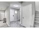 Bright foyer featuring modern gray flooring, neutral walls, and staircase at 6250 W Flamingo Rd # 43, Las Vegas, NV 89103
