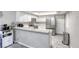 Spacious kitchen with stainless steel refrigerator, white cabinets and breakfast bar at 6250 W Flamingo Rd # 43, Las Vegas, NV 89103