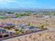 Captivating aerial view of a desert neighborhood featuring a house with a pool and solar panels at 6311 Baker Creek St, Las Vegas, NV 89149