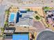 Aerial view of the home features a pool, solar panels, basketball court, lush landscaping, and an RV parking area at 6311 Baker Creek St, Las Vegas, NV 89149