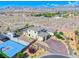 Expansive desert home boasts lush landscaping, brick driveway, basketball court, and an RV parking spot with mountain views at 6311 Baker Creek St, Las Vegas, NV 89149