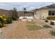 Spacious backyard with desert landscaping, a basketball hoop, and a horseshoe pit for outdoor fun at 6311 Baker Creek St, Las Vegas, NV 89149