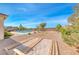 Beautiful backyard showcasing desert landscaping, a pergola, and a sparkling pool at 6311 Baker Creek St, Las Vegas, NV 89149