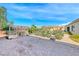 Lush backyard garden area with desert landscaping and a comfortable fire pit at 6311 Baker Creek St, Las Vegas, NV 89149