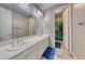 Bright bathroom featuring a double vanity, large mirror, and shower at 6311 Baker Creek St, Las Vegas, NV 89149