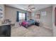 Cozy bedroom with a ceiling fan, window with blinds, and carpet flooring at 6311 Baker Creek St, Las Vegas, NV 89149