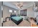 Spacious bedroom with ceiling fan, window with blinds, and wall decorations at 6311 Baker Creek St, Las Vegas, NV 89149