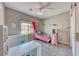 Cozy bedroom featuring neutral walls, ceiling fan and built-in shelving at 6311 Baker Creek St, Las Vegas, NV 89149