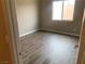 Bright, empty bedroom with sleek hardwood floors and a window providing natural light for a modern feel at 6311 Baker Creek St, Las Vegas, NV 89149
