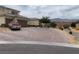 Attractive home showing a brick driveway, desert landscaping, and mountain views at 6311 Baker Creek St, Las Vegas, NV 89149