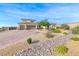 Two-story stucco home with desert landscaping, two-car garage and brick driveway at 6311 Baker Creek St, Las Vegas, NV 89149