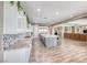 Open concept kitchen with large island, stainless steel appliances, and seamless flow to living area at 6311 Baker Creek St, Las Vegas, NV 89149