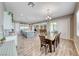 Open dining and kitchen area featuring an island with seating and stainless steel appliances at 6311 Baker Creek St, Las Vegas, NV 89149
