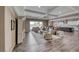 Spacious living room with hardwood floors, a ceiling fan, and lots of natural light at 6311 Baker Creek St, Las Vegas, NV 89149