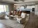 Inviting living room flows into the open kitchen, featuring a comfortable sectional sofa and recliner at 6311 Baker Creek St, Las Vegas, NV 89149
