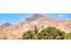 Picturesque mountain view behind lush trees, showcasing the serene backdrop of this stunning property at 6311 Baker Creek St, Las Vegas, NV 89149