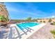 Sparkling pool with poolside patio and lush landscaping, perfect for outdoor entertaining and relaxation at 6311 Baker Creek St, Las Vegas, NV 89149