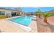 Inviting backyard pool with desert landscaping and a covered pergola dining area at 6311 Baker Creek St, Las Vegas, NV 89149