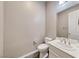 Clean powder room featuring a modern toilet, vanity with sink, and neutral walls at 6311 Baker Creek St, Las Vegas, NV 89149