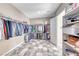 Spacious walk-in closet with rods, shelves, and tiled floor provides ample storage and organization at 6311 Baker Creek St, Las Vegas, NV 89149